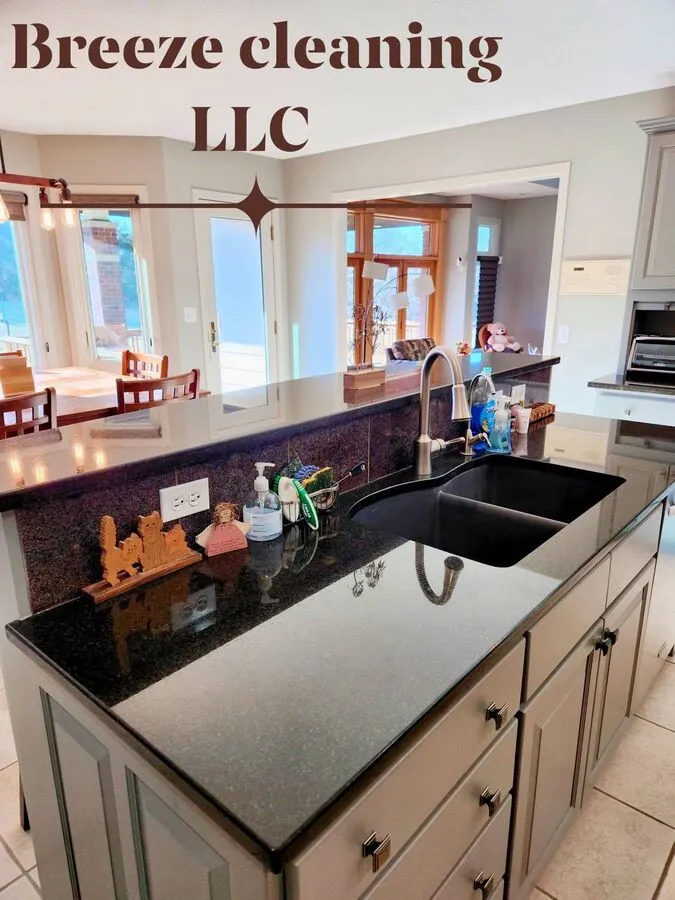 Wide gray kitchen with bar peninsula after cleaning
